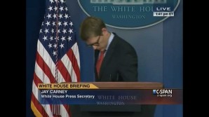 A dejected White House spokesperson Jay Carney walks off stage after explaining ObamaCare website glitches. 