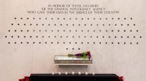A Sacred Commitment: Soon after their deaths, seven ashen stars were chiseled into the smooth white marble of the CIA Memorial Wall, joining a constellation of what is now 111 stars commemorating each of the Agency’s fallen officers. Their names were also etched into the Book of Honor, each beside a 23-carat gold leaf star. 