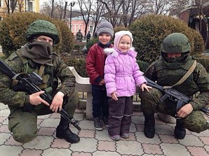 Putin said: "A number of Western countries imposed sanctions and restrictions on Crimea and on Russia as a whole. Our neighbours, it must be said, have not shown much inventiveness. They cut off the water supply or create other problems." Pictured here:  Russian troops pose with children in Crimea. Contrary to western media reports the Russian troops are seen as defenders of the people. Average citizens here don't fear the soldiers...who they know are there to protect them during the reunification process, which include massive rebuilding and investment projects. . 