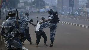 Ugandan police brutally kick and beat an unarmed protester  during a peaceful demonstration against political oppression in that country. 