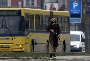 A gunman with an automatic weapon walks in Sarajevo, after he fired shots at the US embassy, October 28, 2011. 
