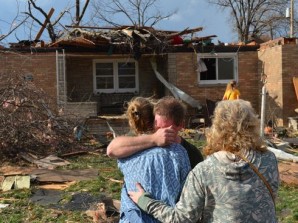 Family grieves home was destroyed by a tornado in Pekin, Ill. November 17, 2013. 