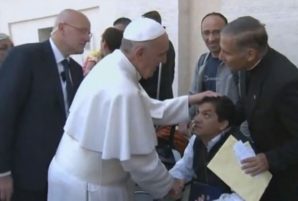 Possessed: A priest leans in to talk to Pope Francis about a disabled man, pictured centre, who is allegedly 'possessed by four demons' following the mass in St Peter's Square... 