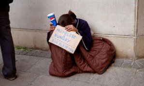 To ashamed to look up - a woman begs for help in the street, as people walk past her. 
