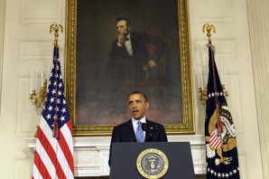 Under the watchful eye of Lincoln portrait - President Barack Obama speaks in the State Dining Room at the White House Saturday, Nov. 23, 2013, in Washington. 