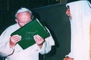 Pope Paul kisses a copy of the Quran. 