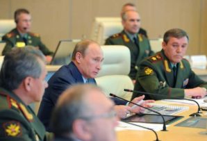 Putin with Russian military commanders ponder US military presence in the Arctic as a serious threat to their national security. 
