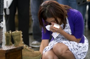 A woman mourns her husband death at his graveside...