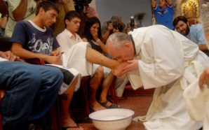 Pope Francis "kisses" the feet of a poor person after washing it with his tears. 