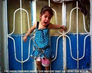 Members of the Free Syrian Army, backed by the United States - chains a girl to a fence as they murder her parents - they later murdered her. Her crime - being Shiite Muslim. 