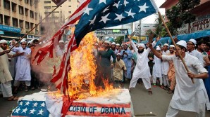 Pakistani protesters burn American flags in 2014. 