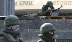 Russian troops stand at the ready to defend key military sites in Crimea. 