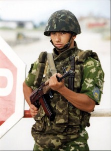 Ukrainian soldier stands on guard outside a Urkrainan military site. 