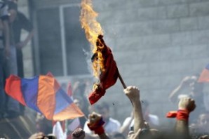 Lebanese Armenians burn the Turkish flag during a protest outside the Turkish embassy in Rabieh, northeast of Beirut, to mark the anniversary of the 97th anniversary of the Armenian genocide in Turkey. 