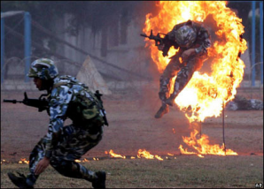 Chinese soldiers go through a grueling live fire obstacle course, including fire hoops to jump through in  Beijing, China in 2012. 