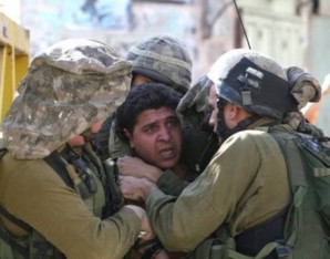 Israeli soldiers effect an arrest of Palestinian man in Hebron. 