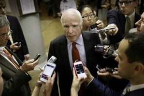 Senator McCain surrounded by reporters in Phoenix asking questions concerning the VA hospital situation. 