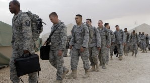 Over 3,000 US troops have secretly returned to Iraq via Kuwait. Pictured here US Air Force personnel load unto a bus to Iraq. 