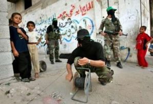 Hamas fighter croaches near children which is uses as human shields against the Israeli Defense force. 