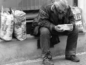Poor & destitute man near 15th avenue and Van Buren in Phoenix, Arizona resorts to eating out of garbage cans to satisfy the pains of hunger in America. 