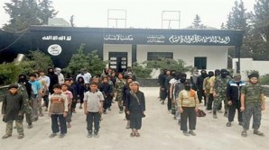 photo of young boys lined up in front of a recruiting center  for ISIL, in the Syrian town of Al-Bab.