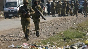 Pakistani troops react to gun fire near their position by running towards it!