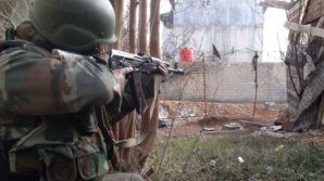 Syrian army soldier takes aim at fleeing ISIS terrorists near Aleppo. 