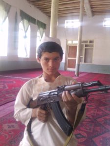 Child holding AK-47 inside Mosque in Karachi, Pakistan. 