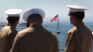 US Marines look on toward the USS America. 