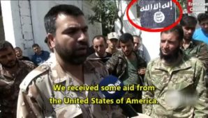 Islamic rebel in Syria admitting they receive aid and funding from the United States - note the ISIL flag in the forground. 
