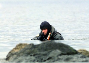  U.S. Marine Cpl. Mark Skolnick scans the shore line as he conducts a beach reconnaissance in Sitka Bay, Alaska, on March 2, 2000, during Exercise Northern Edge 2000.  Northern Edge 2000 is Alaska's largest joint military training exercise involving over 10,000 men and women from all five services.  Skolnick is attached to Echo Company, 4th Marine Reconnaissance Battalion.