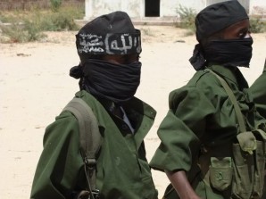 Al-Shabaab child soldier receives military training and instruction at terrorist camp in Somalia. 