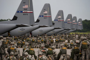 Soldiers from the U.S. Army’s 82nd Airborne Division ready their gear prior to a mass parachute jump from Air Force C-130J Hercules aircraft during a Joint Operation. 
