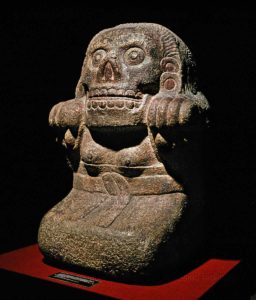 Human sacrifice was a key religious practice characteristic of pre-Columbian Aztec civilization. Pictured here: The infamous Aztec statue of Xochipilli, the god of art, beauty, and games, in a trance and moaning under the influence of the psychotropic flowers that ornament his body. The worship of idols was part of the long cultural tradition of human sacrifice in Mesoamerica that stretched back thousands of years...Limestone statue, currently located at the Museo Nacional de Antropologia, Mexico. Workers there believe it is haunted. 