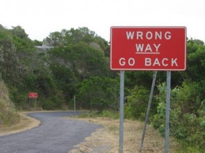 A wrong way sign warning people to "go back." 