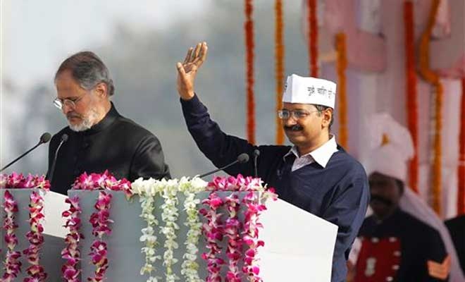 Lieutenant Governor Mr. Najeeb Jung administering the oath of to AAP Leader Mr. Arvind Kejriwal as the Chief Minister of Delhi on 14-02-2015. 
