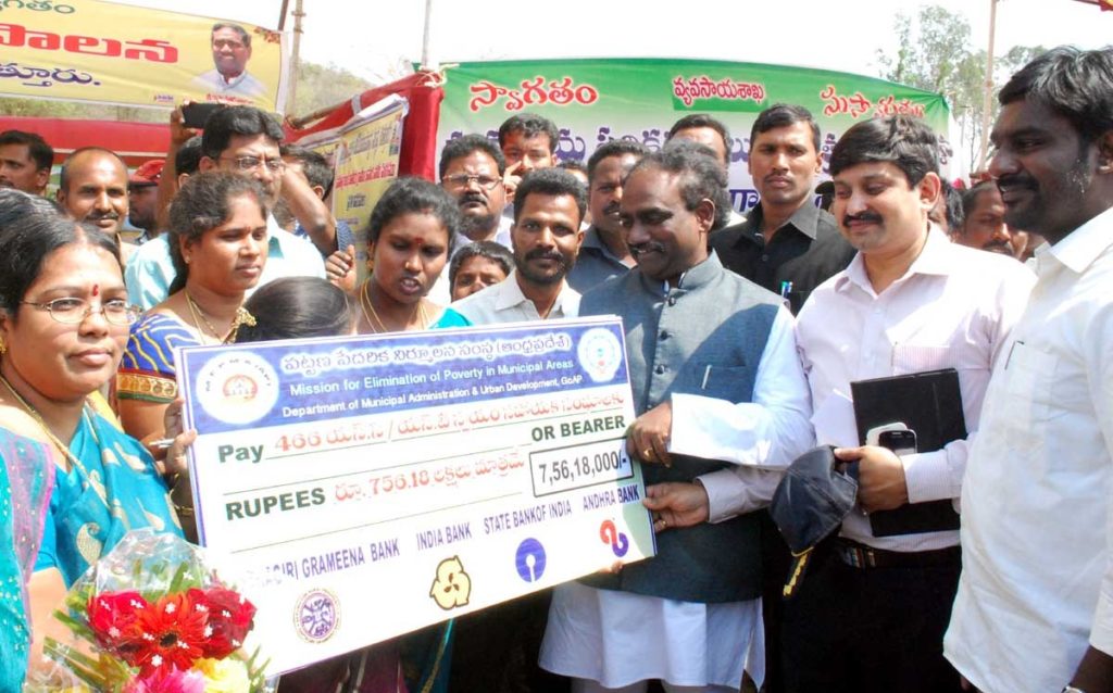 Social Welfare Minister of Andhra Pradesh Mr. Ravela Kishore distributing cheques in Chandranna Samkshema Palana Programme at PVKN College, Chittoor on 22-02-2015. 