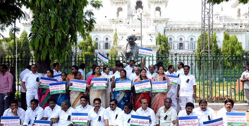 The YSR Congress Party MLAs staging a dharna by holding pla-cards in front of Mahatma Gandhi’s statue in AP Assembly, Hyderabad on 23-03-2015. 