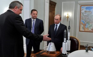 With Deputy Prime Minister Dmitry Rogozin and Roscosmos Head Igor Komarov. Note the scale model of rocket boster design and capsule. These models were until recently classified information. 