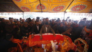 Senior leaders of Nepali Congress party lay the party flag on the body of late former Prime Minister Sushil Koirala in Kathmandu, Nepal, February 9, 2016. REUTERS/Navesh Chitrakar