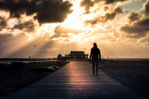 woman walking towards the sun