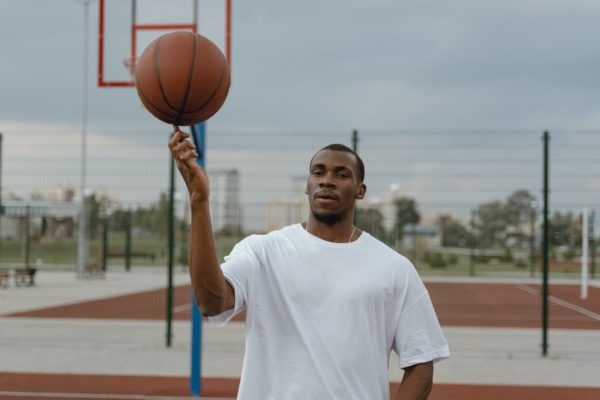 man in white crew neck t shirt holding basketball